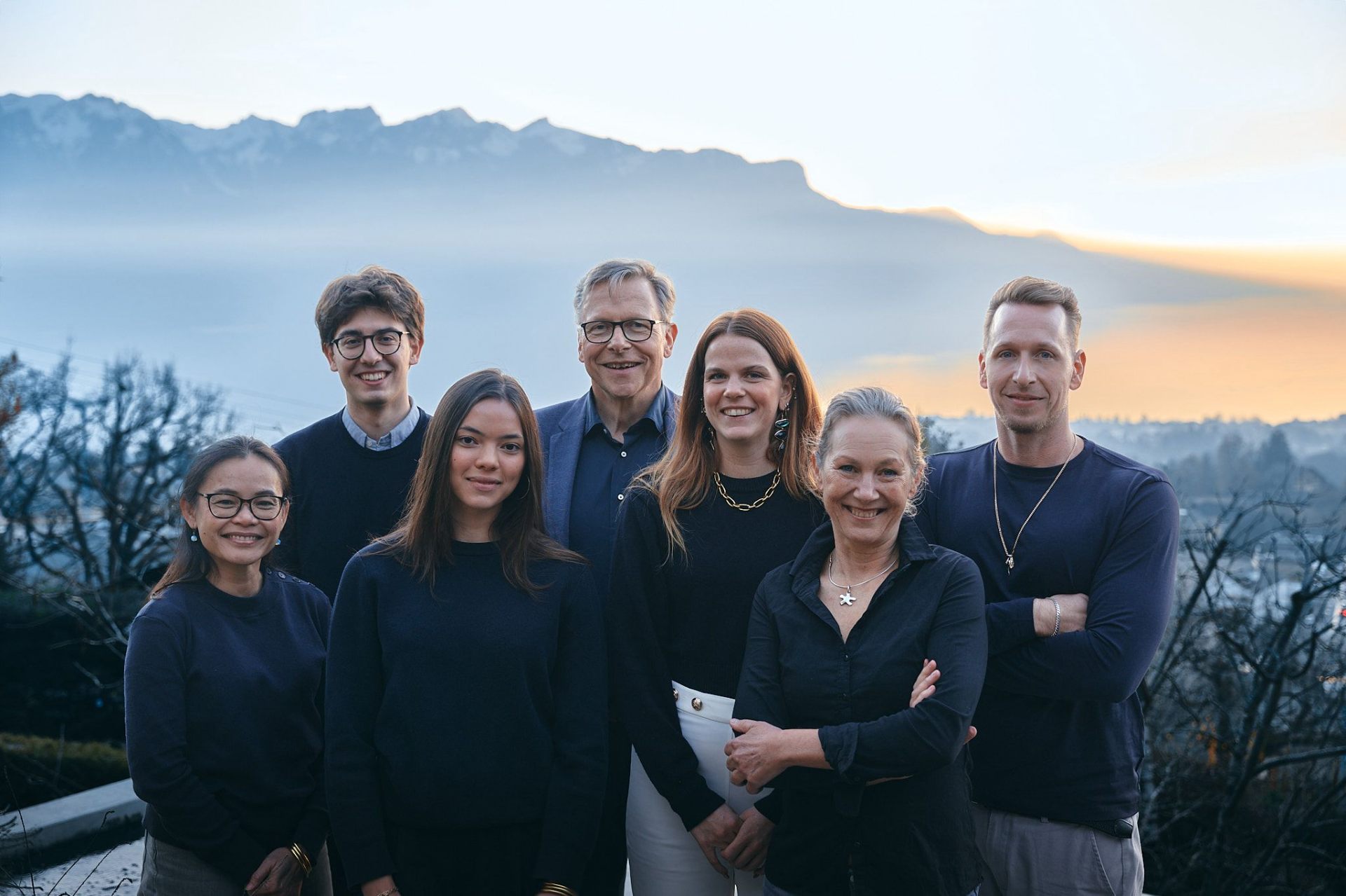The WaveMedix team, standing together above Lake Geneva at dusk.